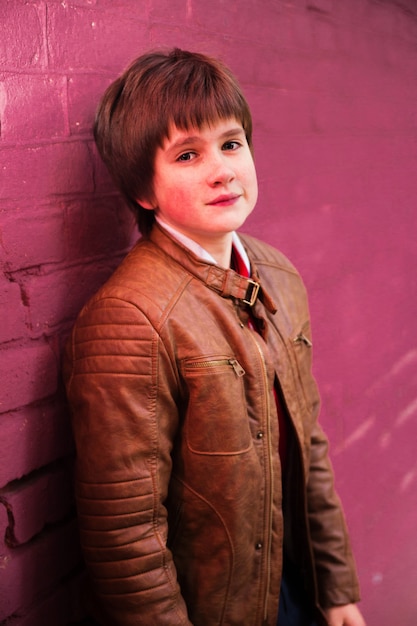 Boy teenager posing against a brick wall background