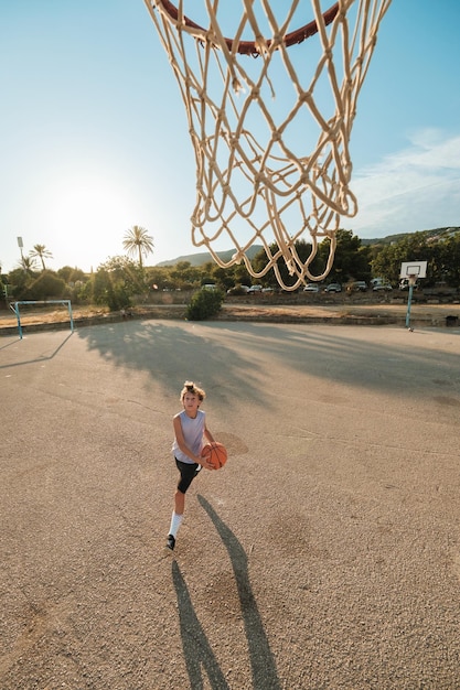 Boy throwing basketball into hoop