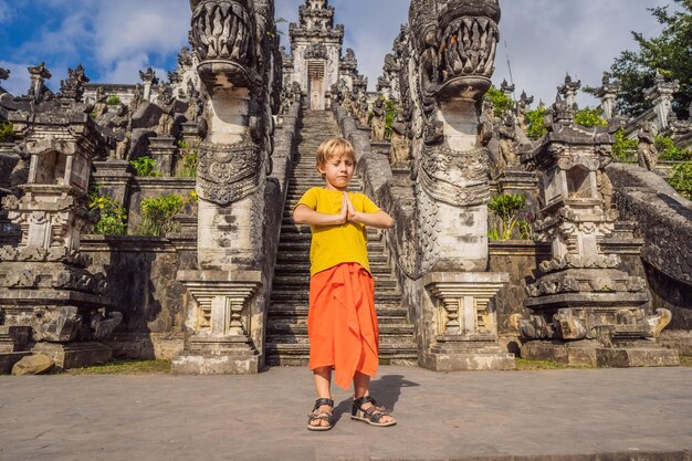 Boy tourist on background of three stone ladders in beautiful pura lempuyang luhur temple paduraksa