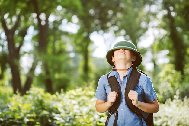 Boy traveler in helmet play in the park.