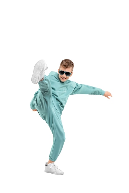 Boy in a turquoise suit and white sneakers isolated on a white.