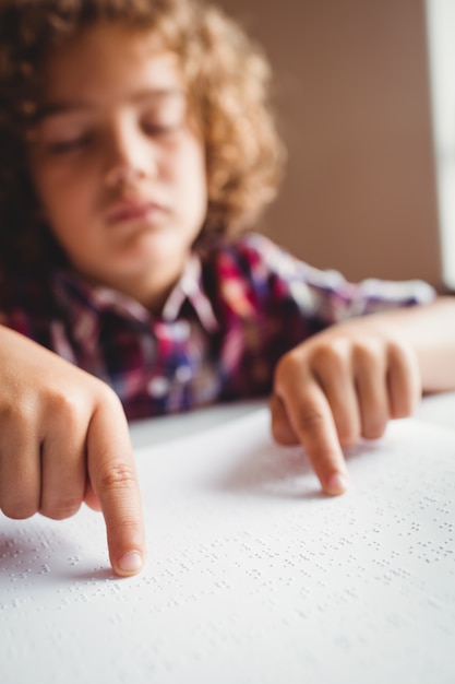 Boy using braille to read