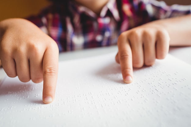 Boy using braille to read