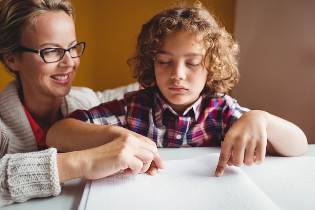 Boy using braille to read