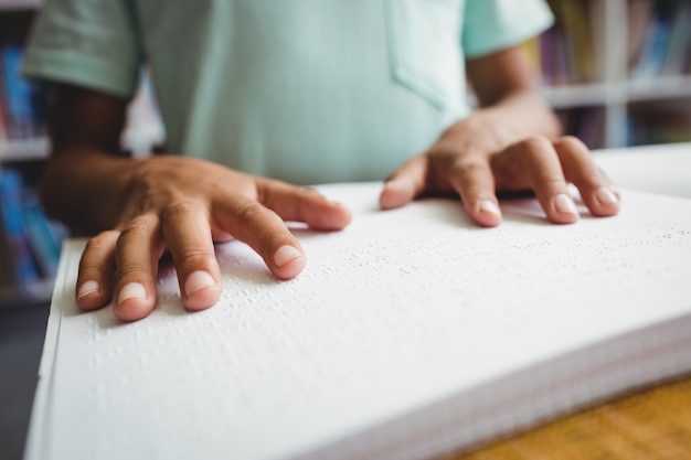 Boy using braille to read