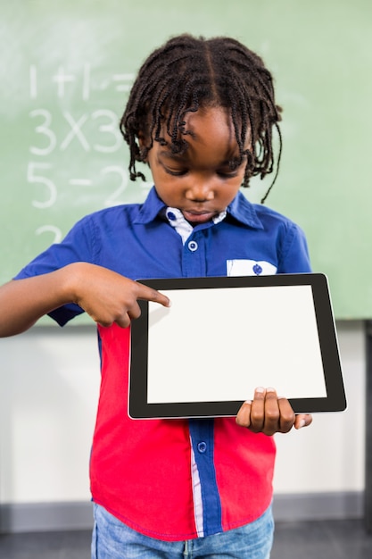 Boy using digital tablet in classroom