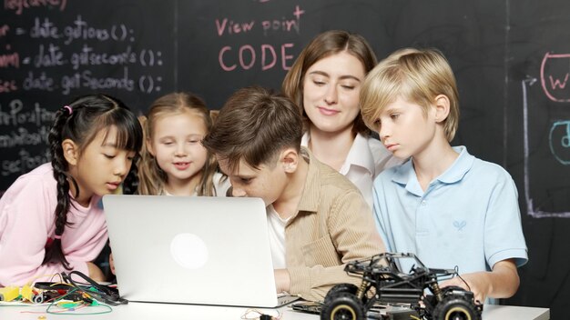 Boy using laptop programing engineering code and writing program Erudition