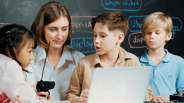 Boy using laptop programing engineering code and writing program Erudition