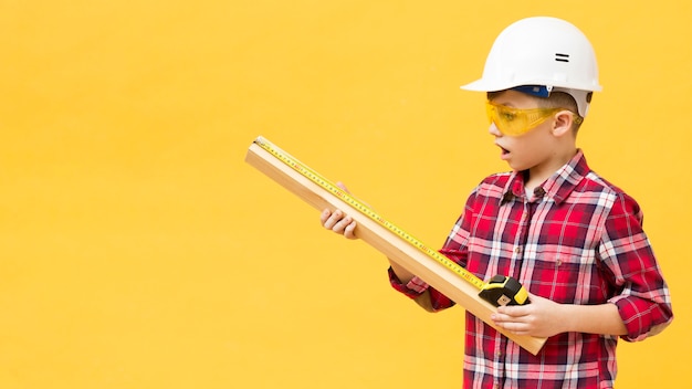 Boy using measuring tape copy space