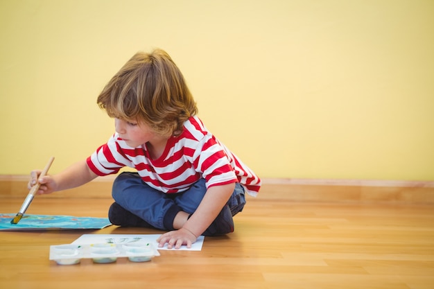 Boy using a paintbrush to paint