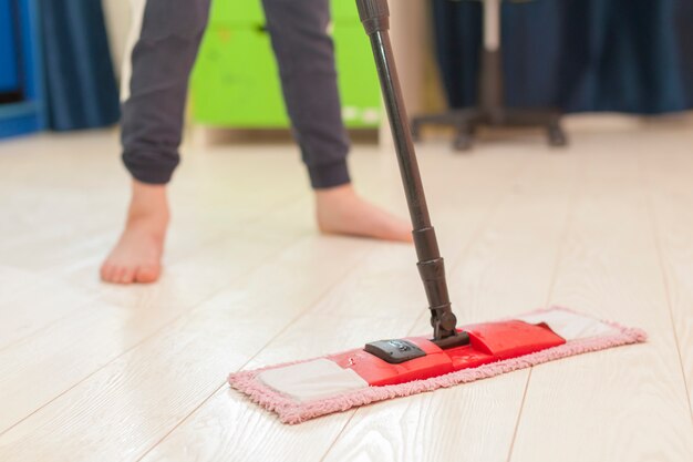 A boy washes floors at home. Occupation at the time of isolation.