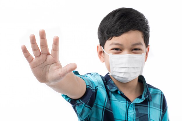 Boy wearing medical mask, rise hand to refuse