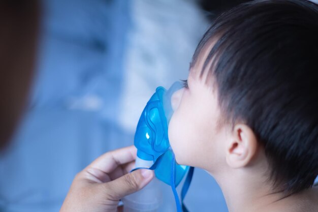 Boy wearing oxygen mask in hospital