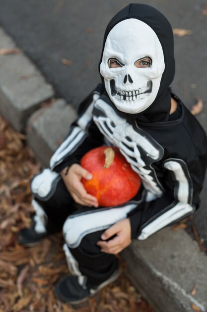 Boy wearing a skeleton costume for Halloween