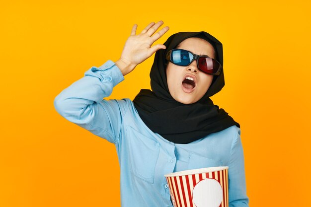 Boy wearing sunglasses against yellow background