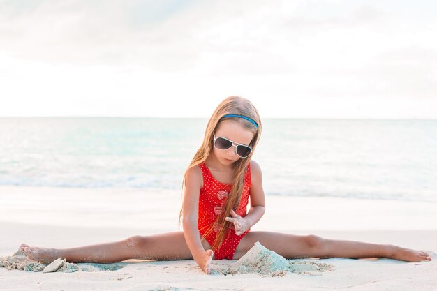 Boy wearing sunglasses on beach against sky