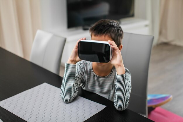 自宅で仮想現実シミュレーターを身に着けている少年