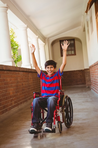 Boy in wheelchair in school corridor