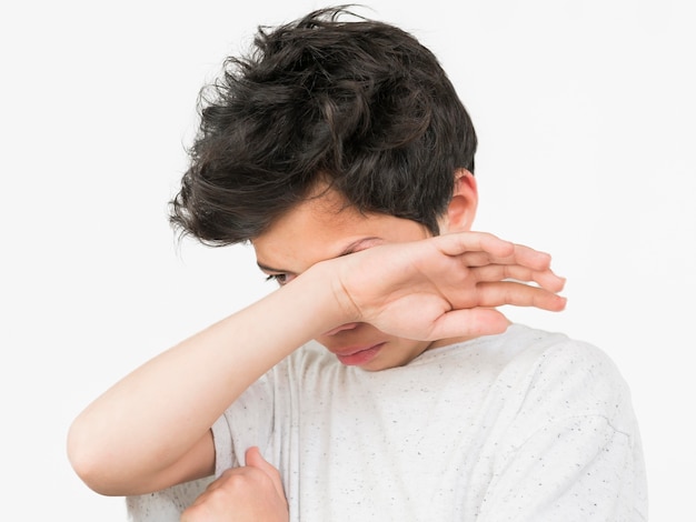 Boy in white t-shirt crying