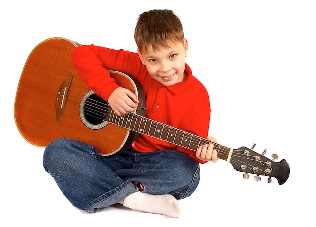 The boy with an acoustic guitar on a white background