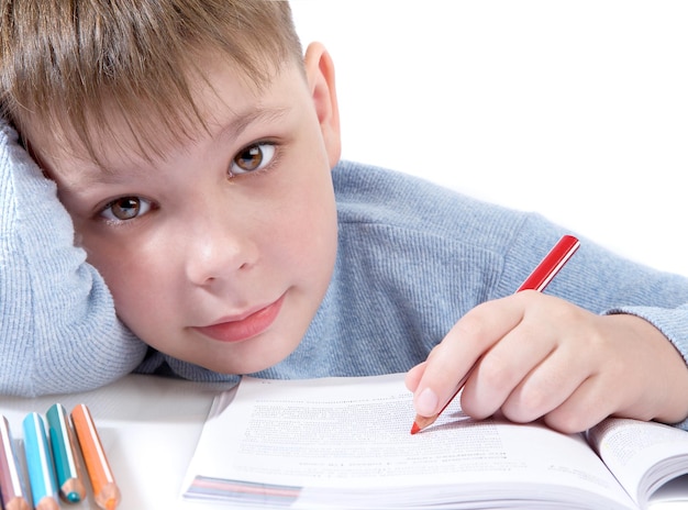 The boy with the book behind a table