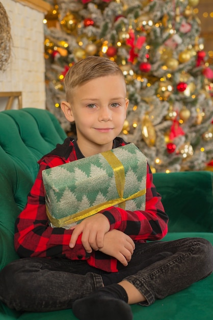 boy with christmas present at home portrait