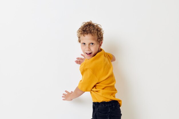 Boy with curly hair in yellow tshirt cropped view