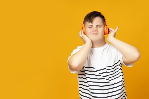 A boy with down syndrome listens to music in headphones