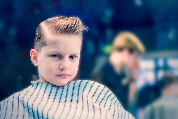 A boy with fashionable haircut looking in camera