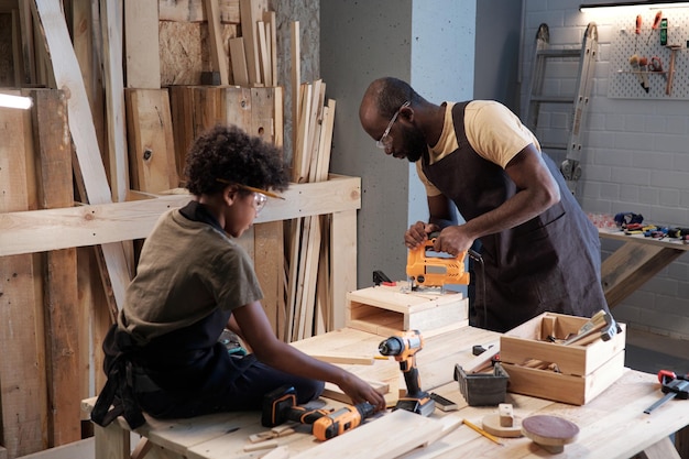 Boy with father in workshop