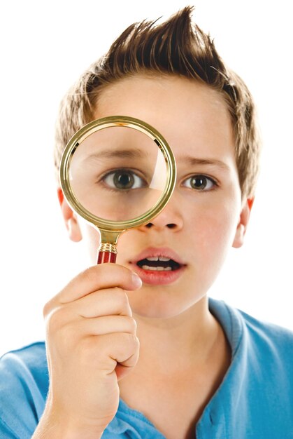 Boy with magnifier isolated on a white background