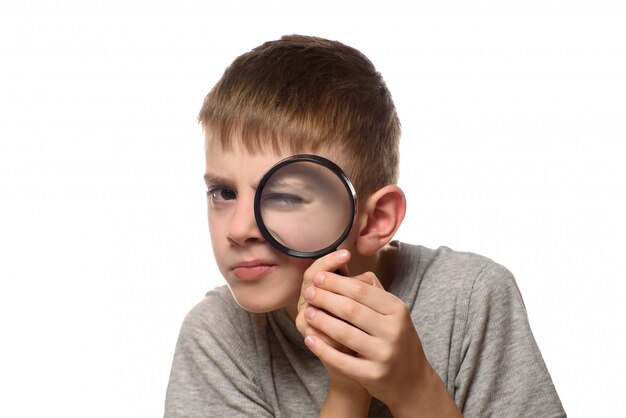 Boy with a magnifying glass in his hands