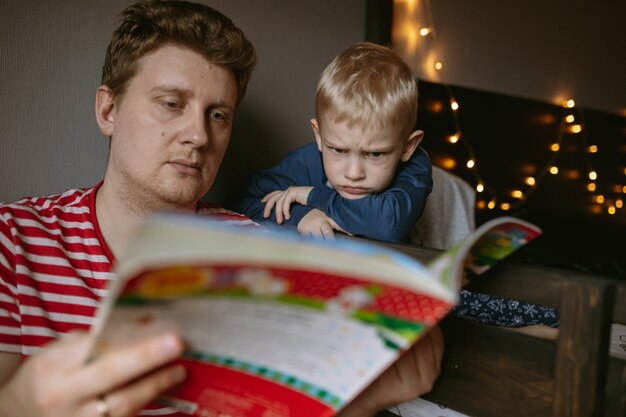 Boy with mother reading christmas book