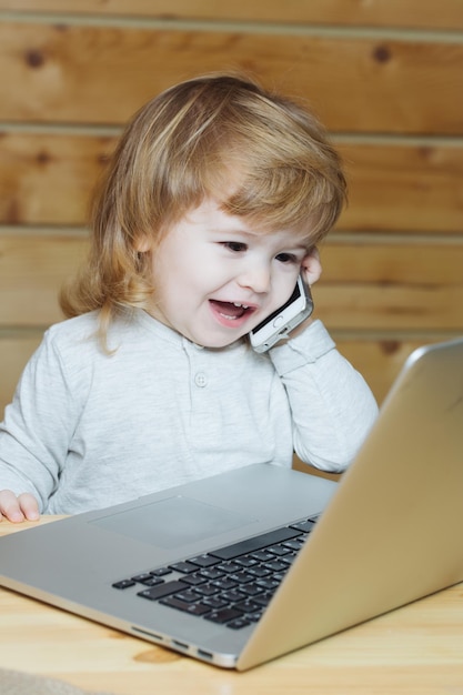 Boy with phone and computer