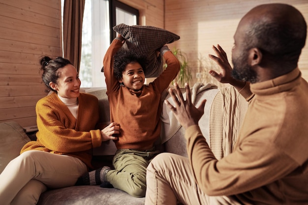 Boy with pillow playing with parents