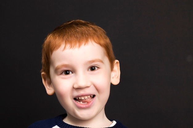 Boy with red hair smiling and laughing