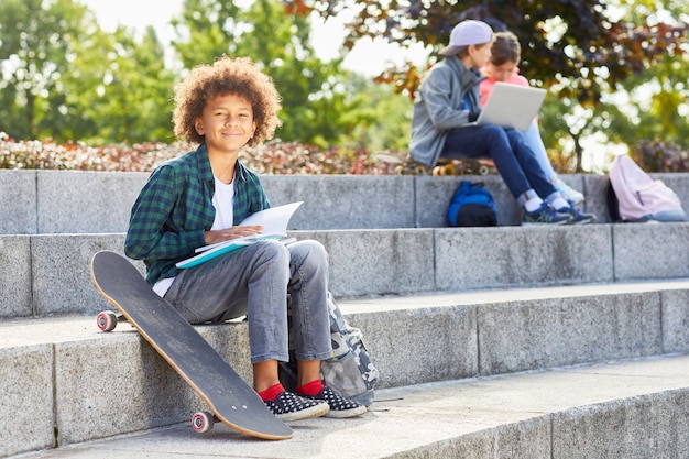 Boy with skateboard outdoors