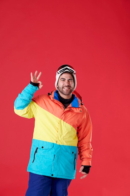 Boy with snowboard clothes doing an okey with his hand