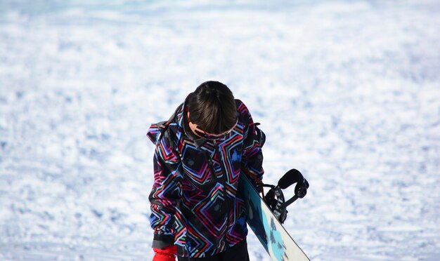 boy with snowboard in the snow