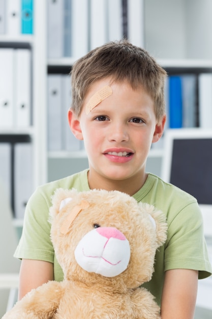 Boy with teddy bear in clinic