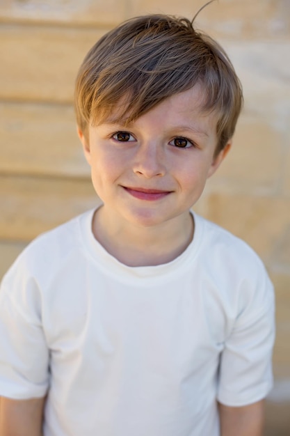 Photo a boy with a white shirt that says quot he is smiling quot