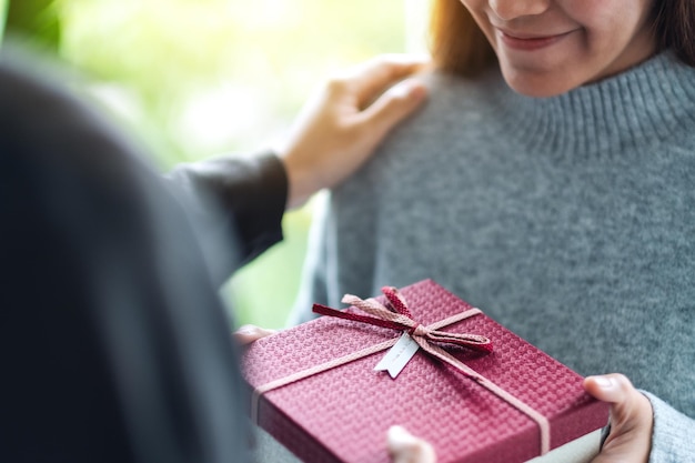 A boyfriend giving his girlfriend a gift box