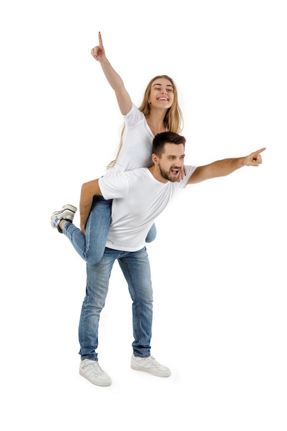 Boyfriend giving piggyback to girlfriend on white background