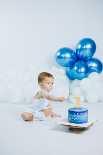 boys first birthday with sweet cake one year old boy eating his first cake