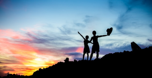 Boys play at sunset.