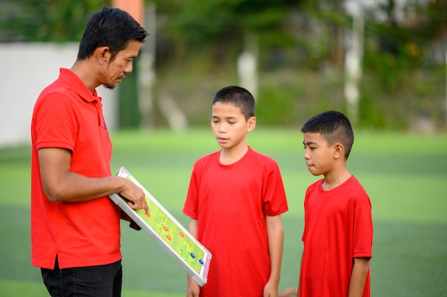 Boys playing football on the football practice field