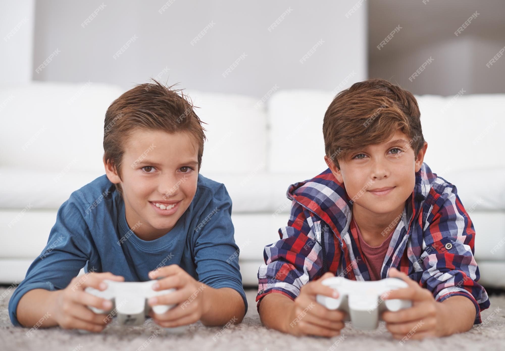 Two boys plays online games in quarantine. Young boys smile and use phone.  One look how play another Stock Photo - Alamy