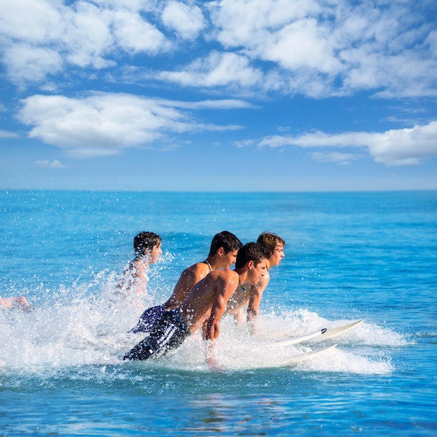 Surfisti maschii che navigano correre che salta sui surf