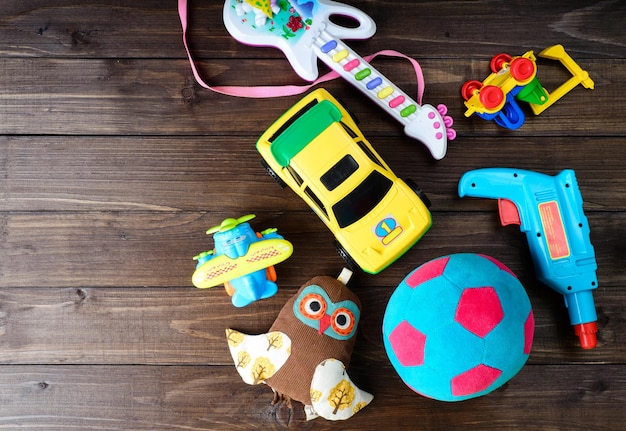 Photo boys toys on wooden background top view