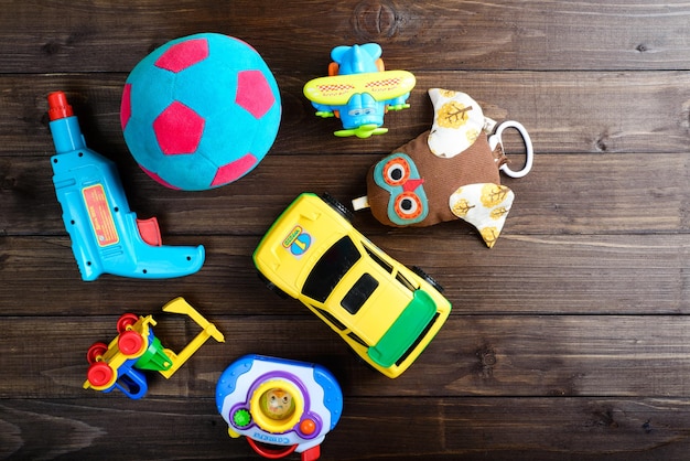 Boys toys on wooden background top view